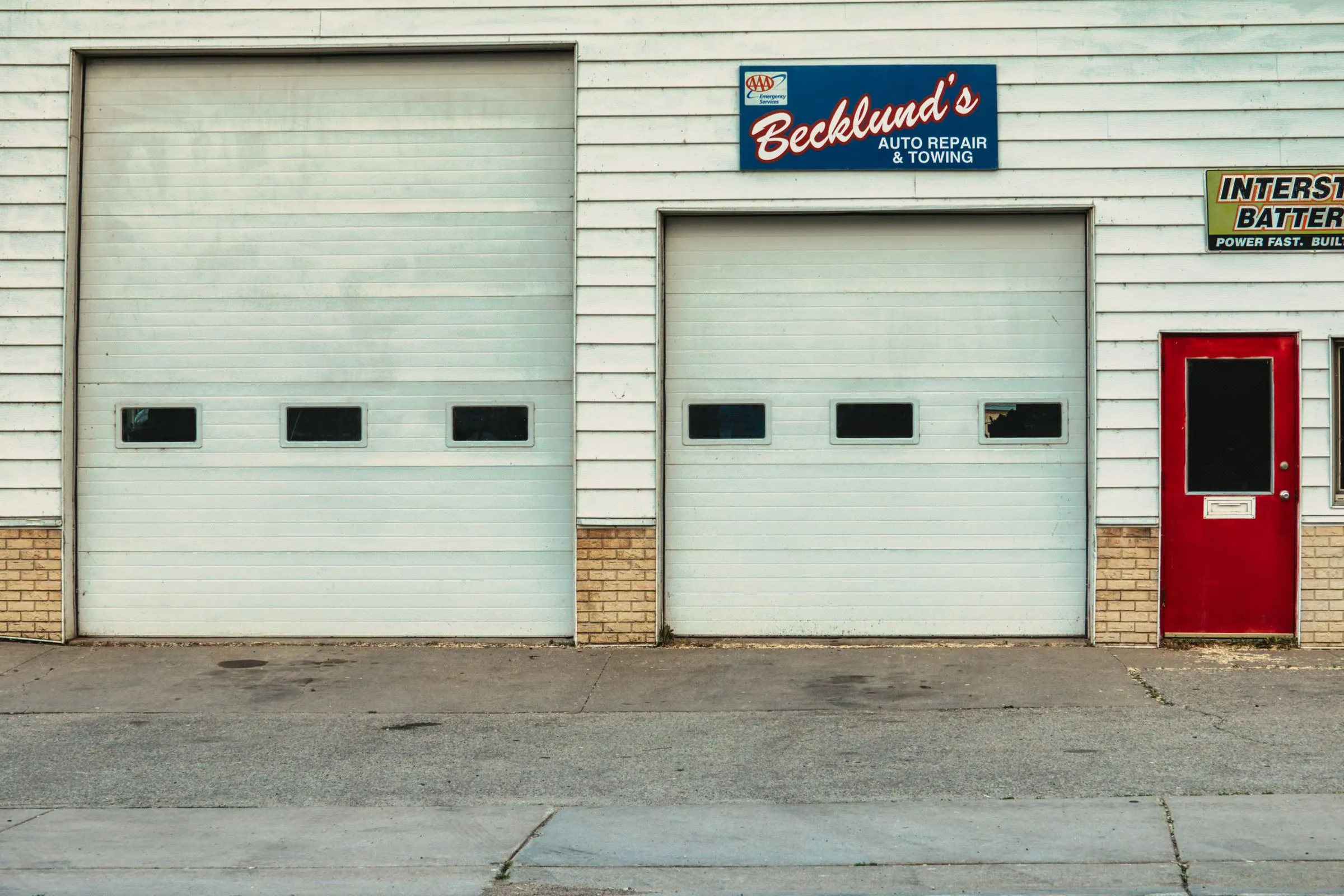 Repair shop storefront with commercial roll-up service doors